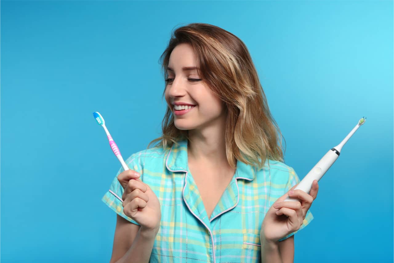 The woman is switching to an electric toothbrush.